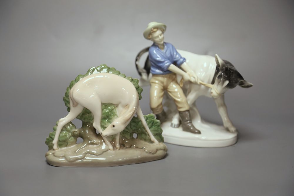 A Royal Copenhagen deer, model 2051 and a Sitzendorf figure group of a man and a cow.